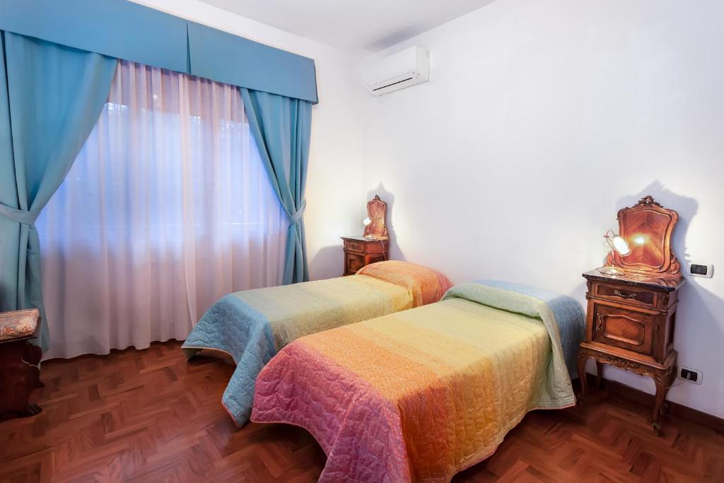 a bedroom with two beds and a window at B&B Appia Felis in Rome