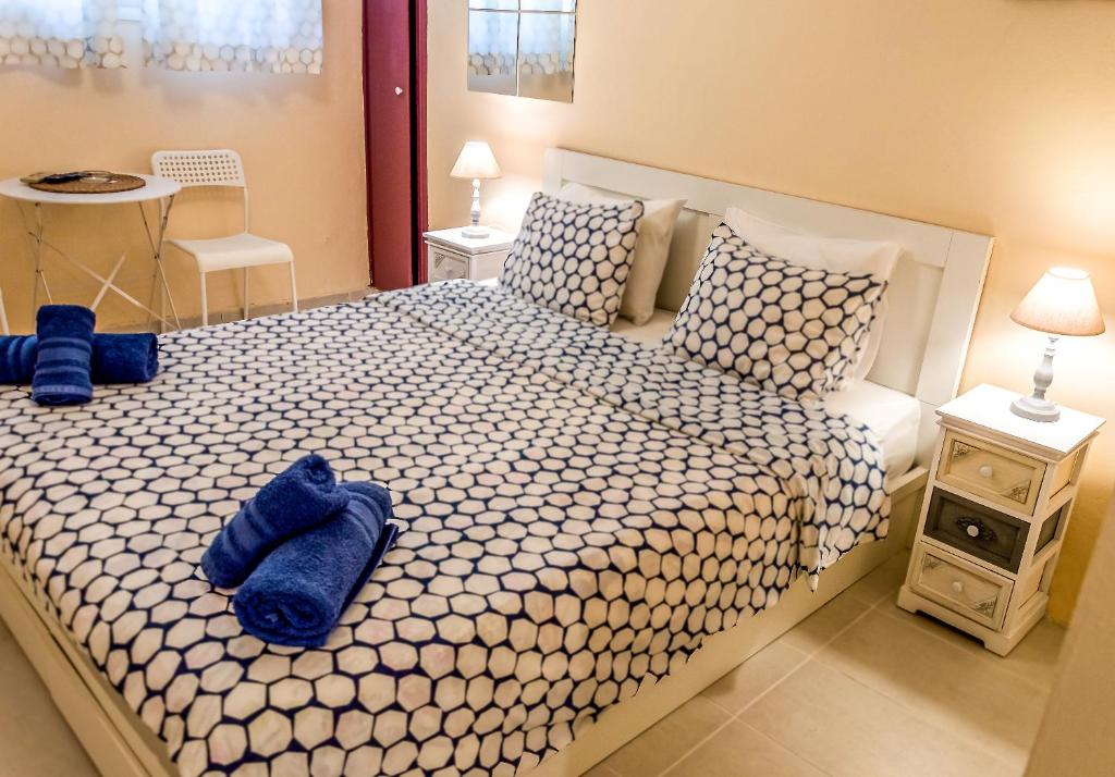 a bedroom with a large bed with blue towels on it at Zoe's Studio in Athens