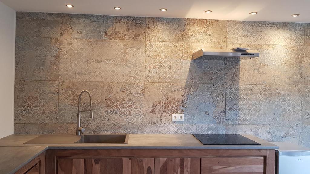 a kitchen with a sink and a counter top at maison neuve en bois près de Pairy Daisa in Brugelette