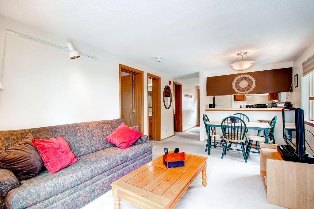 a living room with a couch and a table at Mark IX #8 - Close to Town - Free Shuttle in Breckenridge