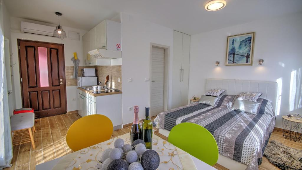 a small bedroom with a bed and a kitchen at Studio apartment Margarita in Opatija