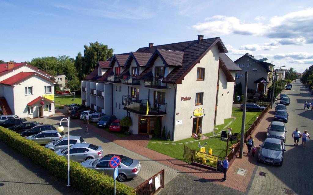 a large building with cars parked in a parking lot at Paleo Premium in Władysławowo