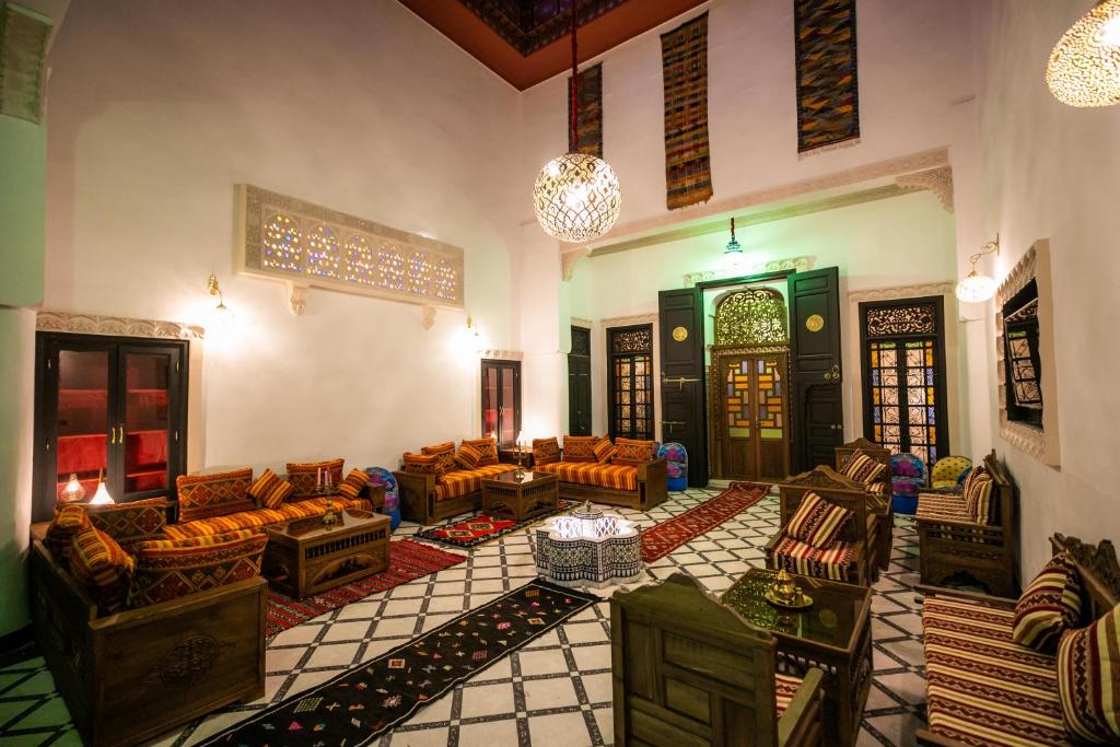 a living room with couches and chairs in a building at Dar Layali Fez in Fez