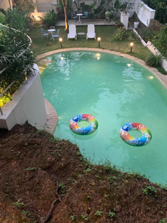 a swimming pool with two inflatables in the water at The Island Sanctuary Rock Pool Villa in Chorao