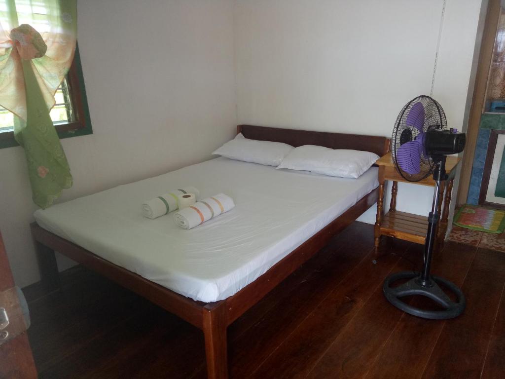Postel nebo postele na pokoji v ubytování Jeno Tourist Inn