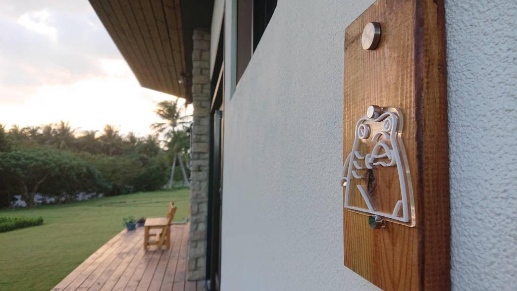 a wooden door with a handle on a house at Shark B&B in Hengchun