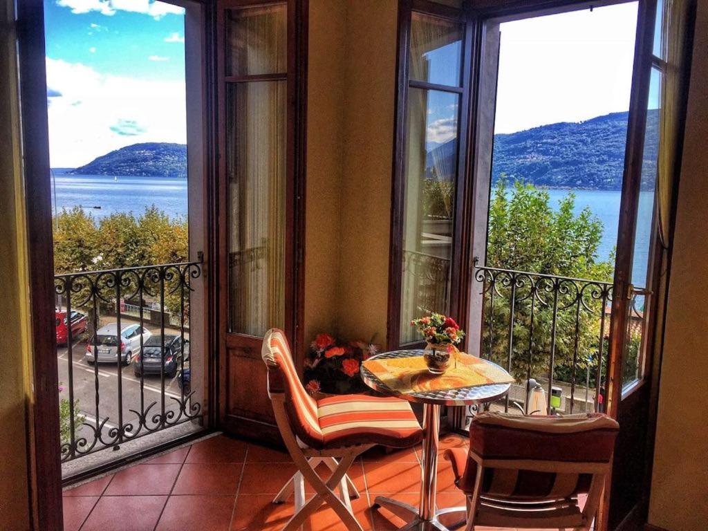a balcony with a table and a view of the water at Incanto Sublime in Verbania