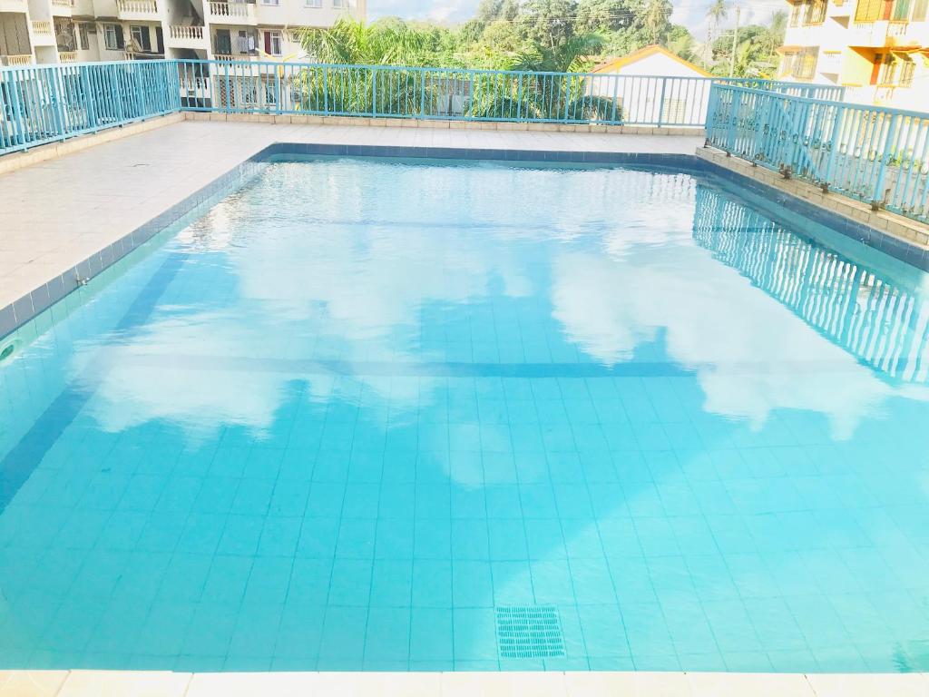 a large swimming pool with blue water at Bandari apartment in Mombasa