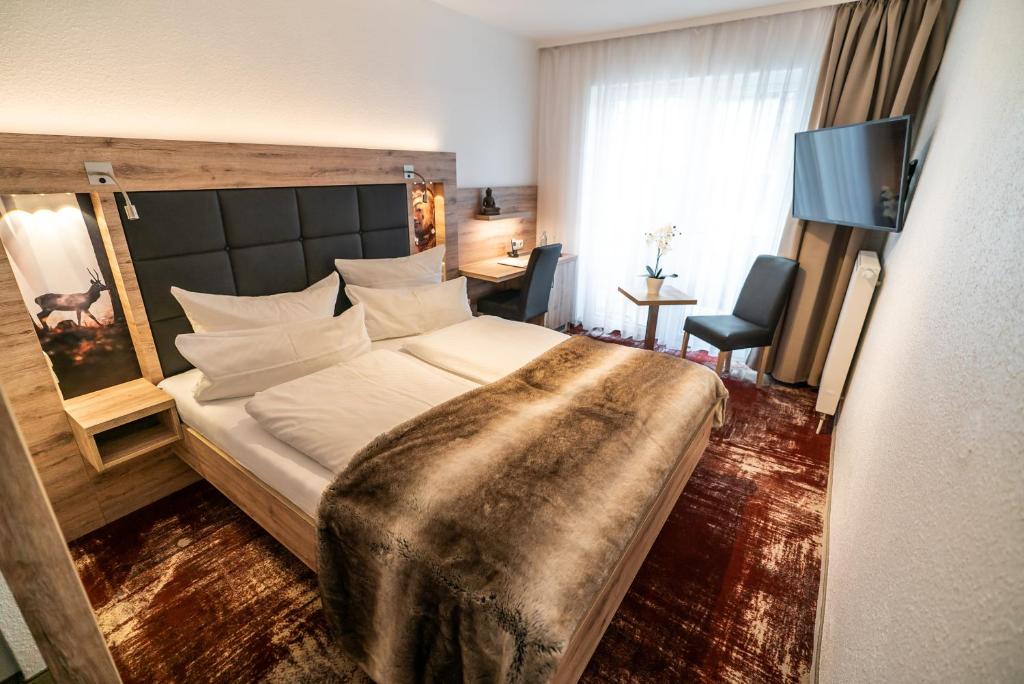 Postel nebo postele na pokoji v ubytování Wellness & Ayurveda Hotel Am Eichenberg
