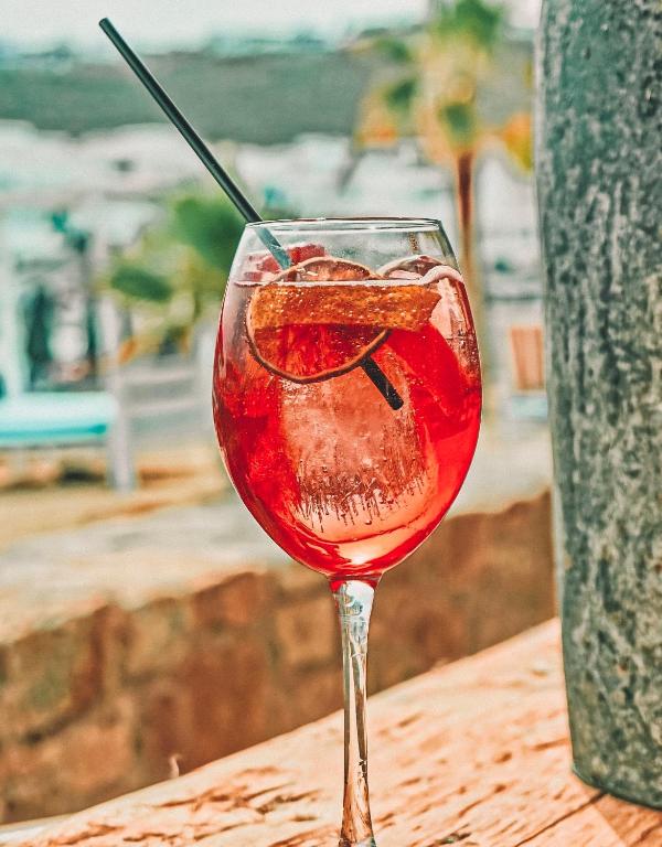 a glass of red wine sitting on a table at Branco Mykonos in Platis Gialos
