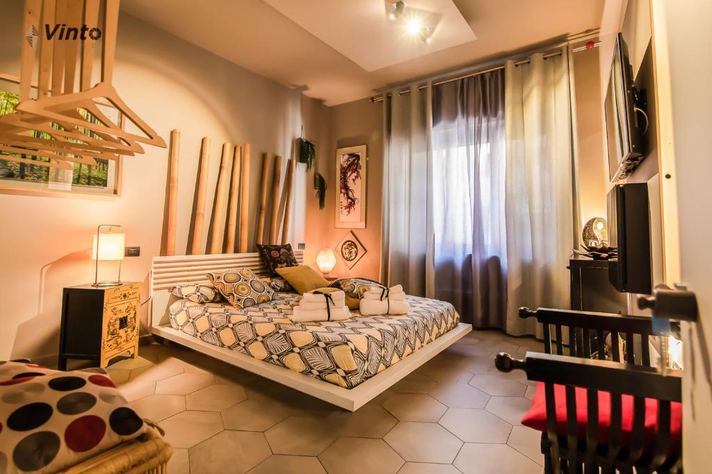 a bedroom with a bed and a television in it at Vinto House Salerno Downtown in Salerno