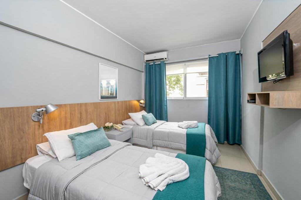 Postel nebo postele na pokoji v ubytování Urbano Hotel
