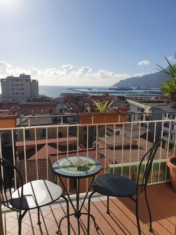 a balcony with two chairs and a table and a view at Oasi al centro con parcheggio in Salerno