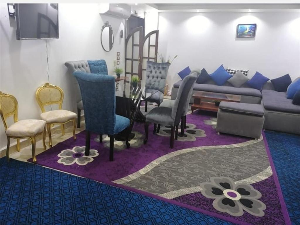 sala de estar con sofá y sillas en Private Family Apartment in Dokki en El Cairo