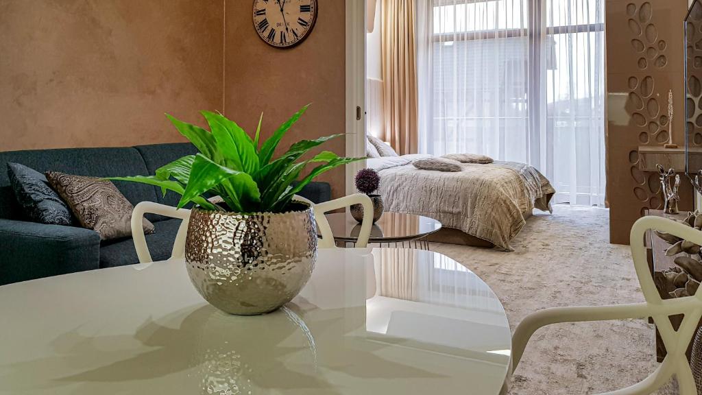 ein Wohnzimmer mit einem Tisch und einer Pflanze darauf in der Unterkunft Apartmán LIANA Hrebienok C107 in Starý Smokovec
