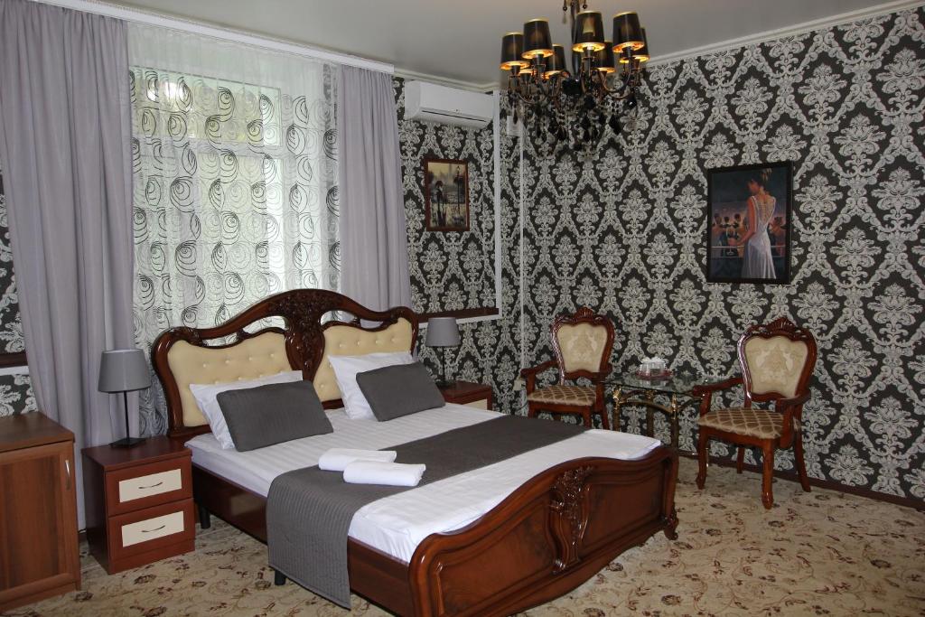 モスクワにあるLefortovsky Dvorik Hotelのベッドルーム1室(ベッド1台、椅子2脚付)