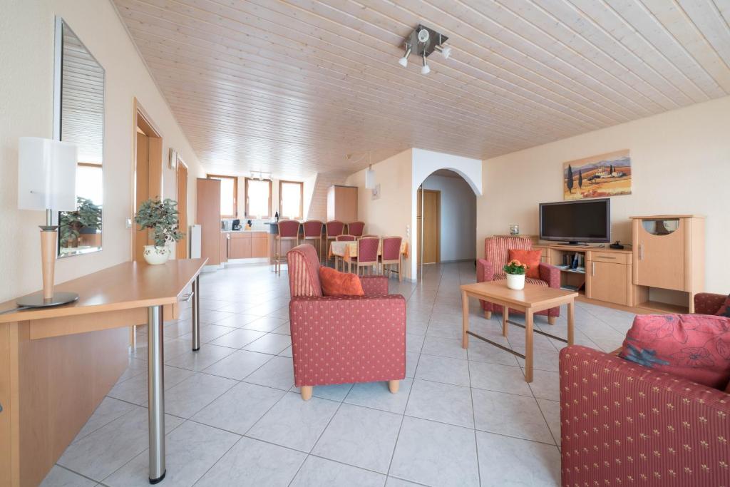 a living room with chairs and a dining room at Fewo im Naturpark in Spiegelberg