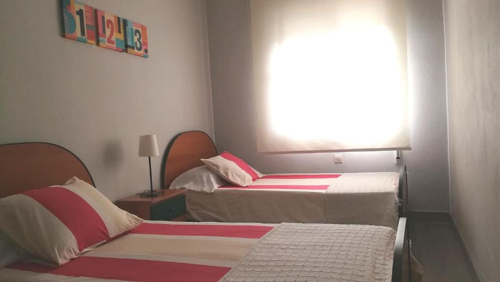 Posteľ alebo postele v izbe v ubytovaní P.B. Apartamento