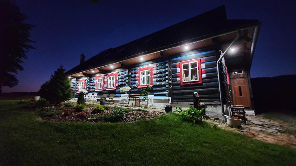 a house with red and blue lights on it at Zdiar Holiday Cottage in Ždiar