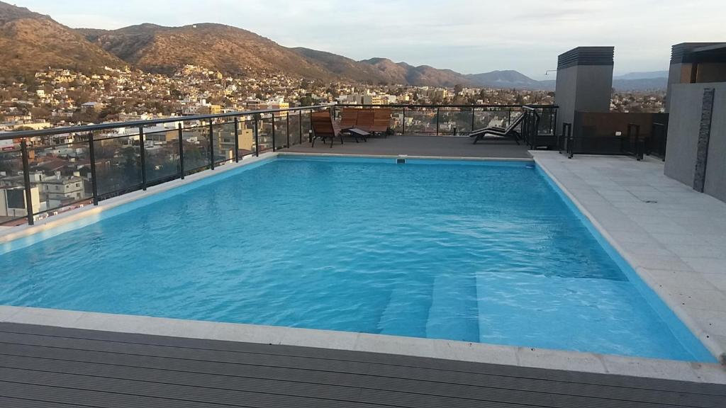 a swimming pool on the roof of a building at Serendipia Carlos Paz in Villa Carlos Paz
