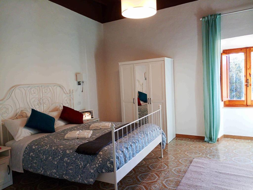 a bedroom with a large bed and a window at Alloggio turistico Porta Franceta in Sutri