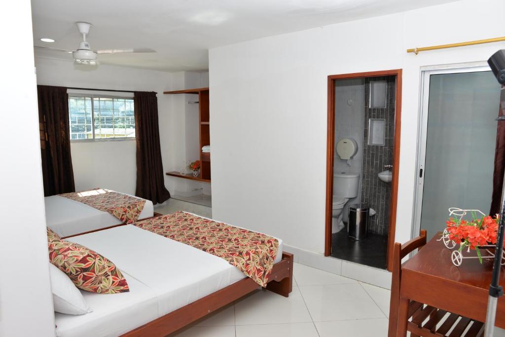 Postel nebo postele na pokoji v ubytování Hotel Canoa Inn