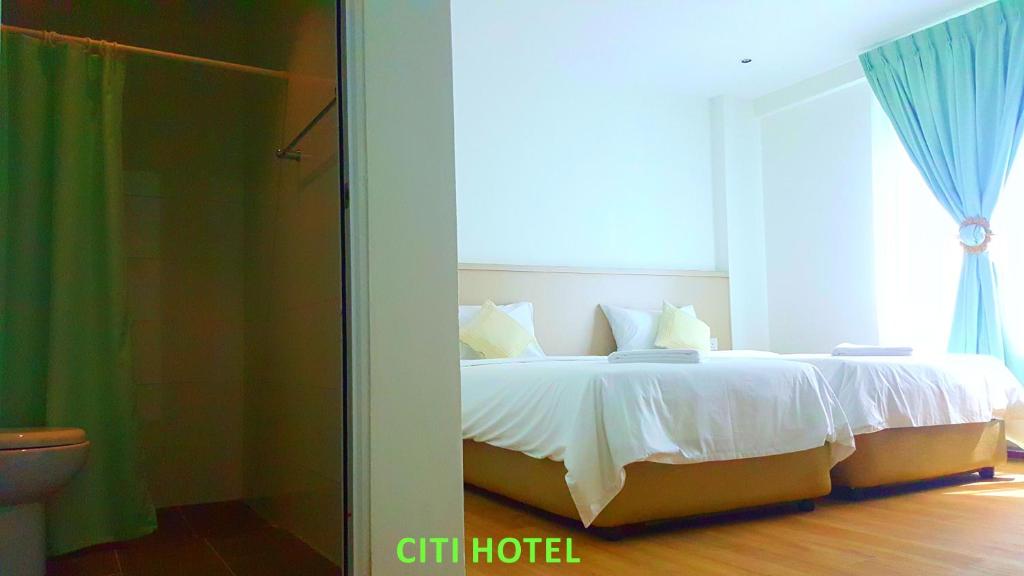 Postel nebo postele na pokoji v ubytování Citi Hotel