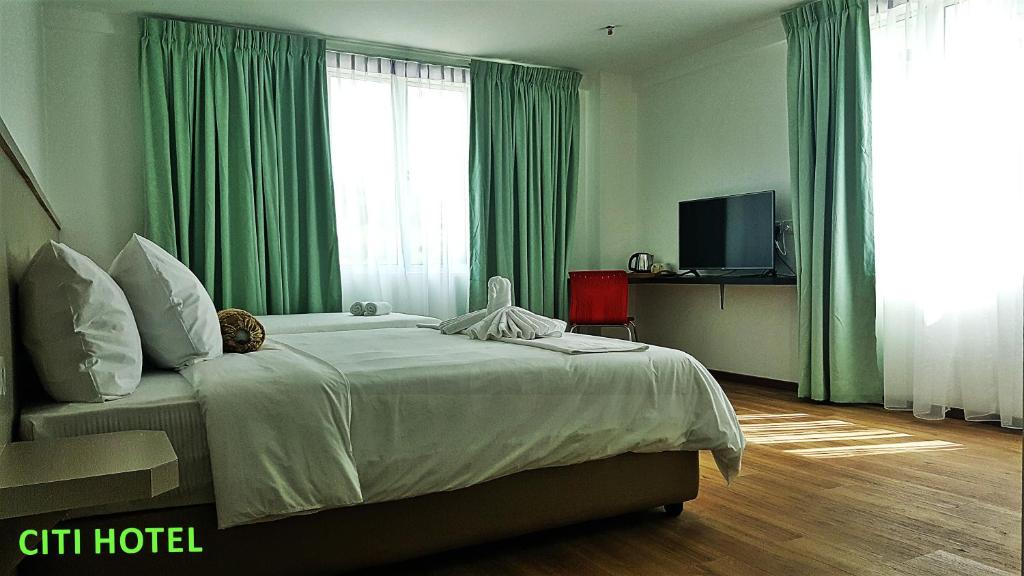 Postel nebo postele na pokoji v ubytování Citi Hotel