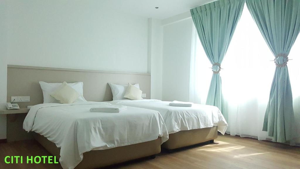 Postel nebo postele na pokoji v ubytování Citi Hotel