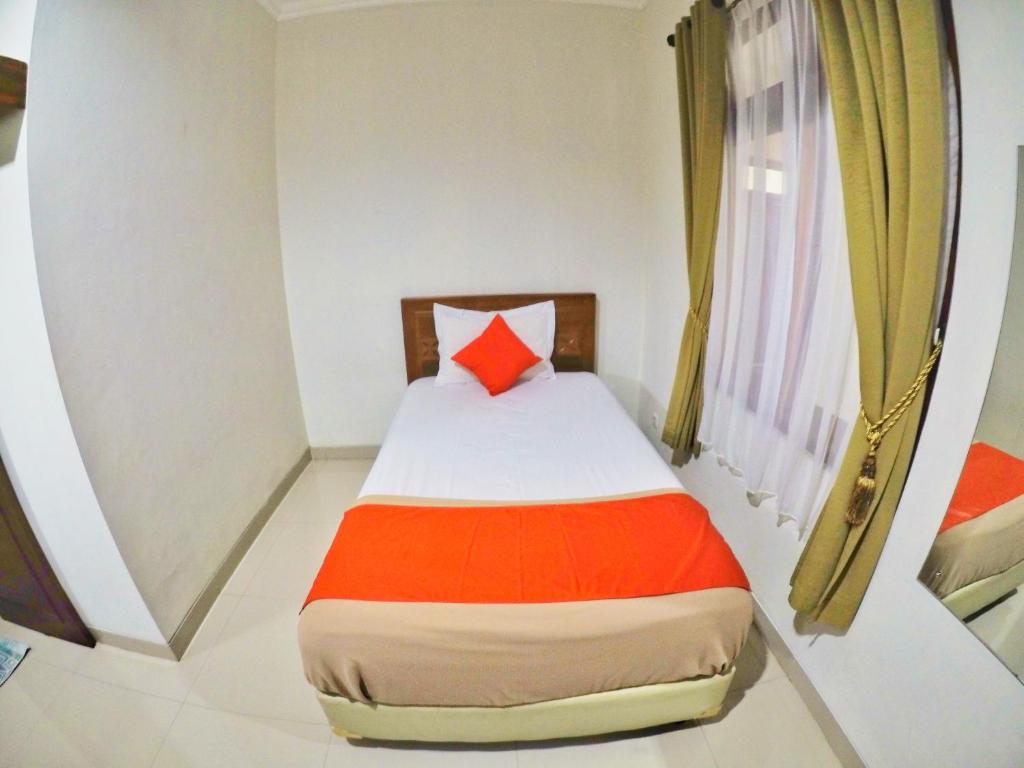 Postel nebo postele na pokoji v ubytování Griya Alsis Residence