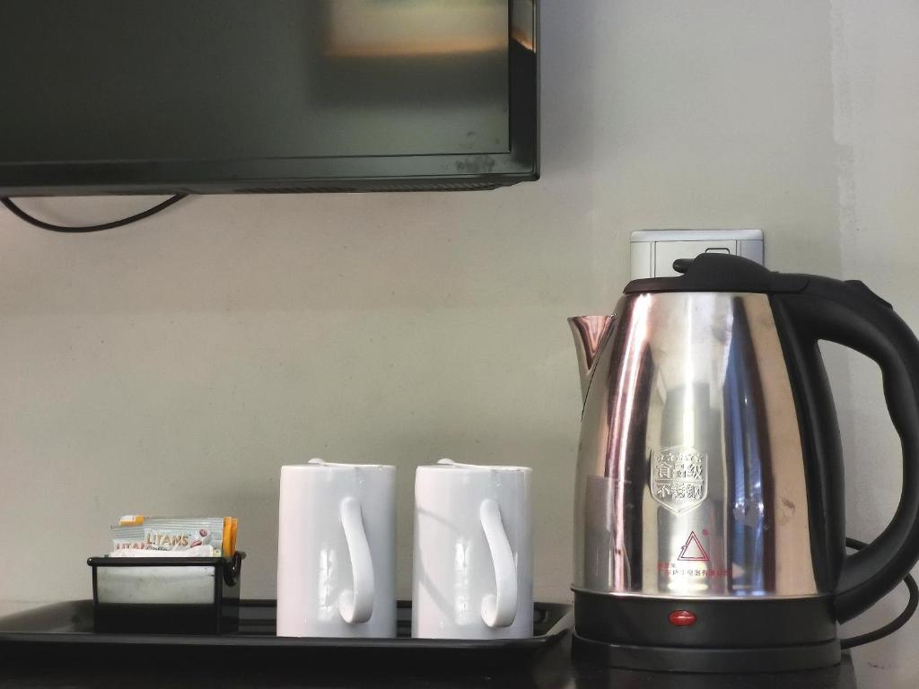 a coffee pot and some paper towels on a counter at Kimberley Hotel Georgetown in George Town