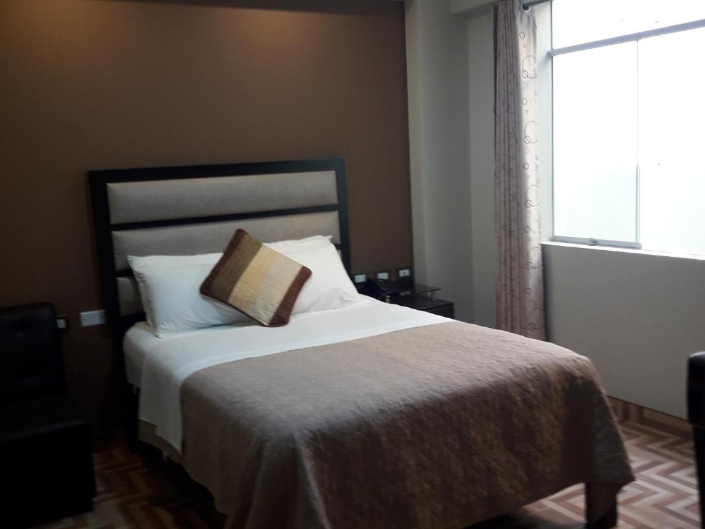 Postel nebo postele na pokoji v ubytování Gavina Inn Hotel
