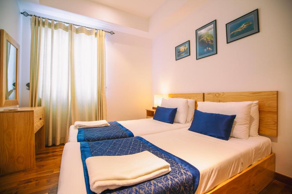 Postel nebo postele na pokoji v ubytování Oceanfront Condominium - Nilaveli