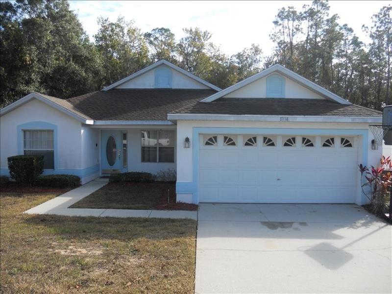 a blue house with a white garage at 34 Thousand House in Davenport