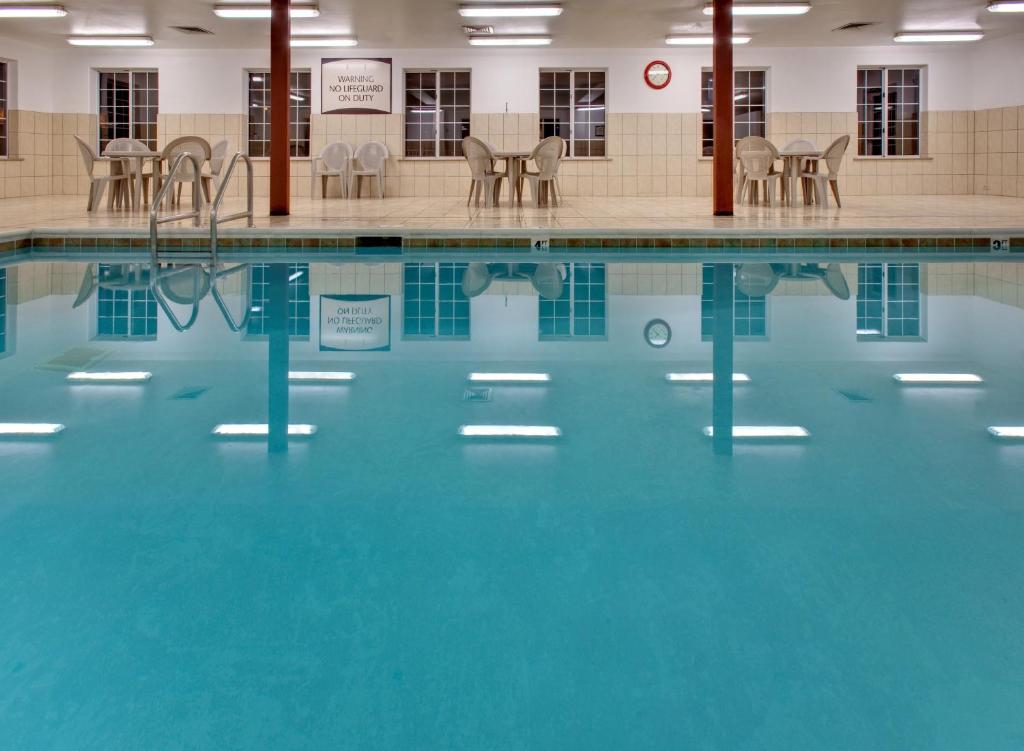 a swimming pool with blue water in a building at Staybridge Suites Rockford by IHG in Rockford