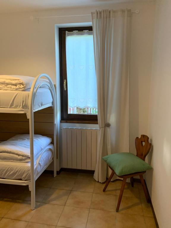 Postel nebo postele na pokoji v ubytování Trilocale Fumeclo