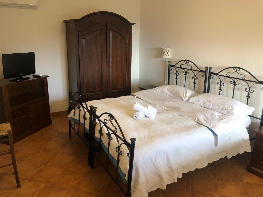a bedroom with a bed with a teddy bear on it at Il Cuccaro B&B-Bike Friendly in Eboli
