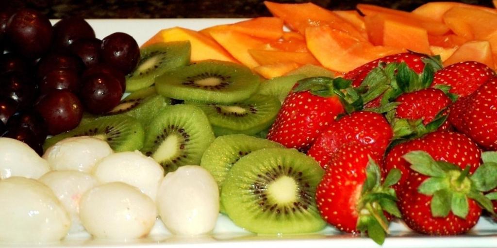 a plate of fruit and vegetables on a table at Casa Mia Guesthouse in Table View