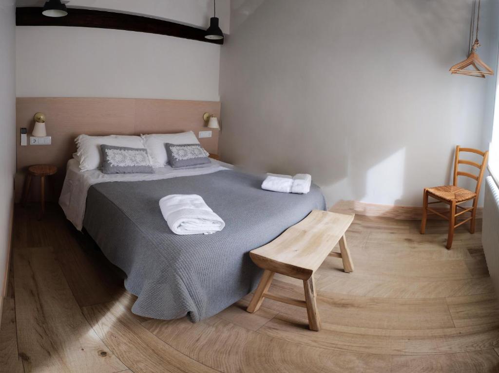 a bedroom with a bed with two towels on it at Atico Estafeta in Pamplona