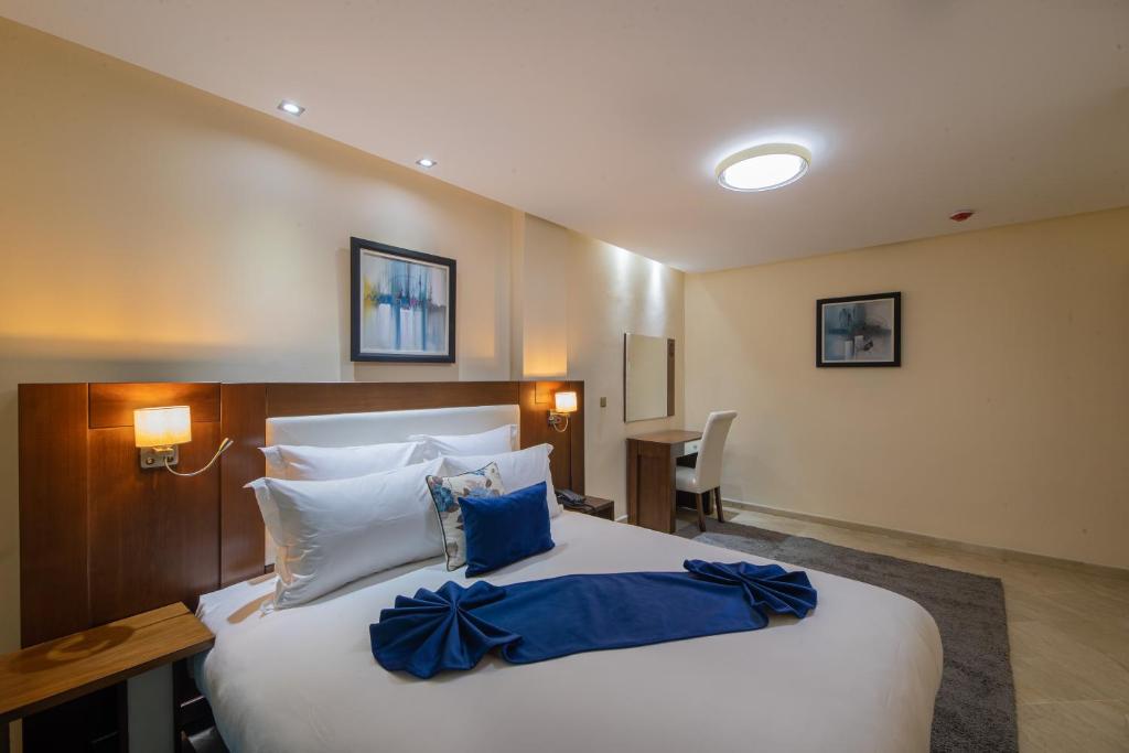 Postel nebo postele na pokoji v ubytování Appart-hotel Marrakech Inn