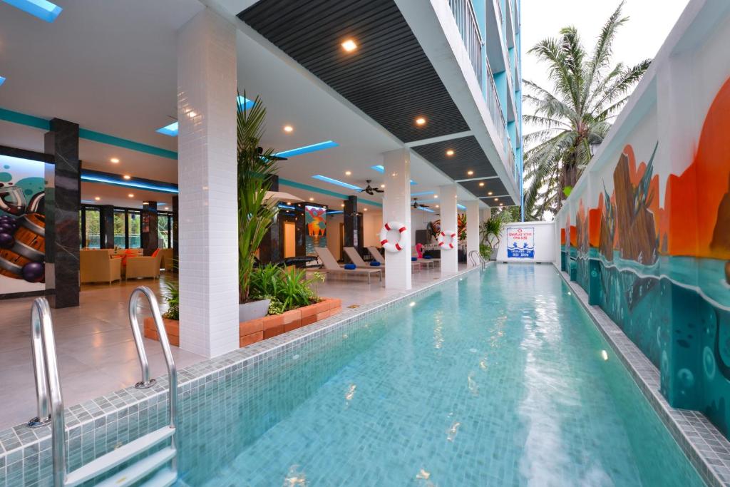 a swimming pool in a building with a swimming poolvisorvisor at T2 Ao Nang Krabi in Ao Nang Beach