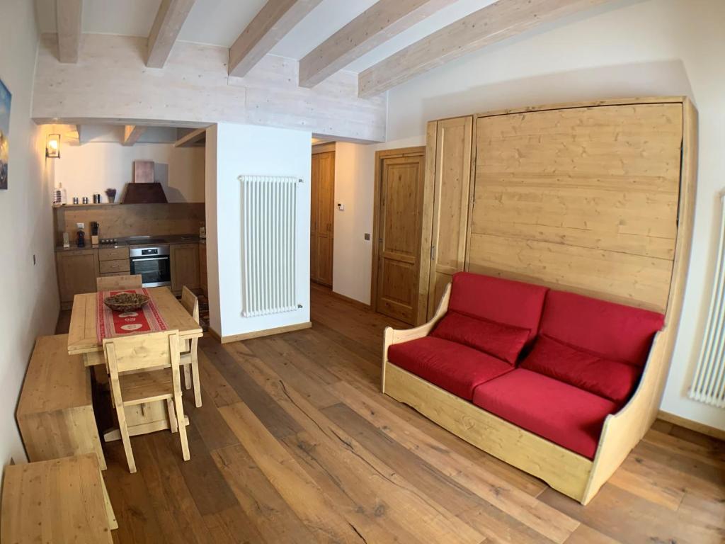 a living room with a red couch and a table at ILIA House in Vason