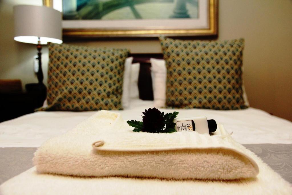 a towel with a bottle of toothpaste on a bed at Casa Mia Guesthouse in Table View