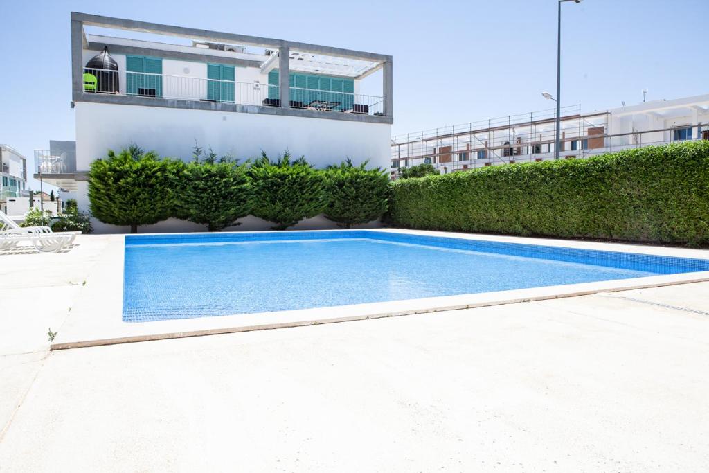 a swimming pool in front of a building at Casa Azul in Cabanas de Tavira