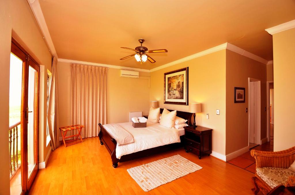 a bedroom with a bed and a ceiling fan at Casa Mia Guesthouse in Table View