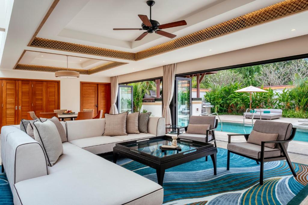 a living room with a white couch and a table at Banyan Tree Phuket in Bang Tao Beach