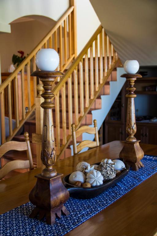 a table with a plate of shells on a table with a staircase at Casa Mia Guesthouse in Table View