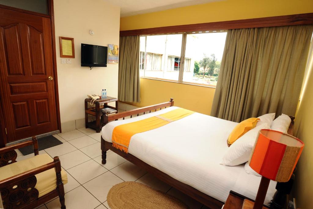Postel nebo postele na pokoji v ubytování Kenya Comfort Suites
