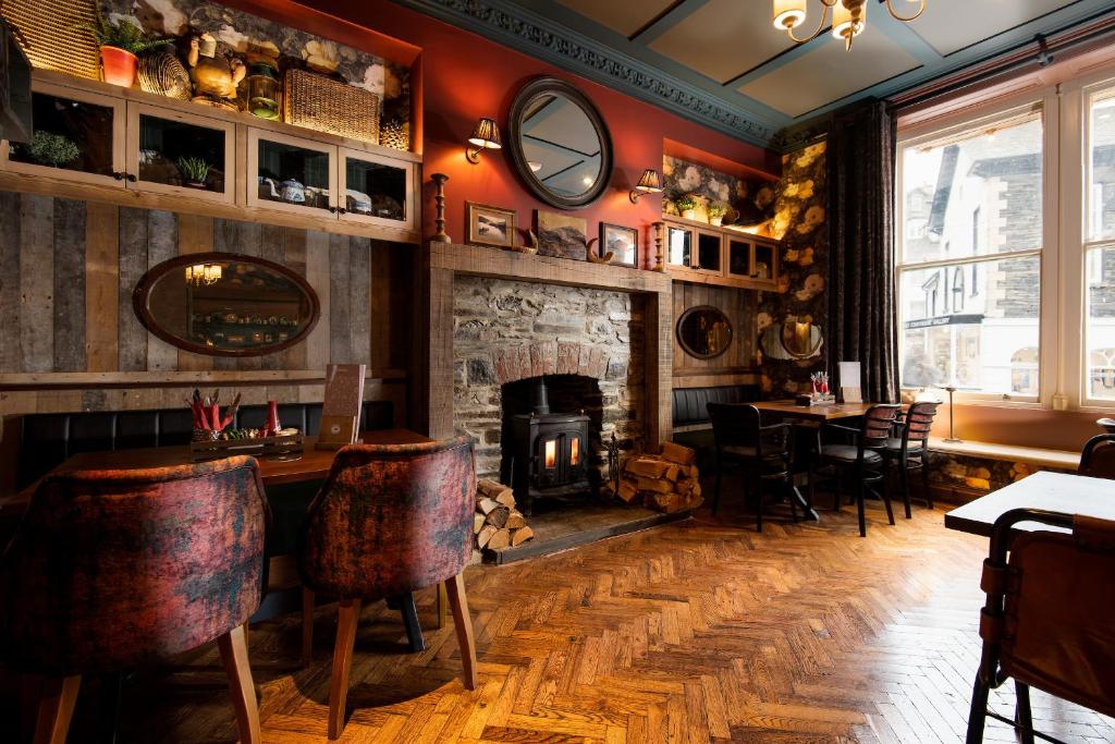 a living room filled with furniture and a fireplace at The Ambleside Inn in Ambleside
