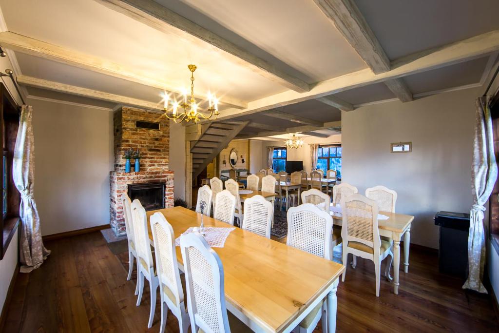 a dining room with a table and white chairs at The Provence Village in Bukovinka